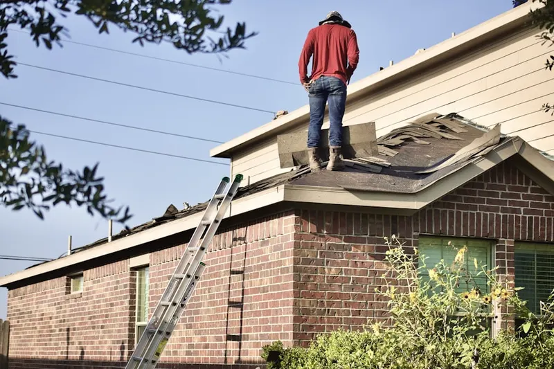 Professional roofer working on a residential roof in Fox Ridge Manor